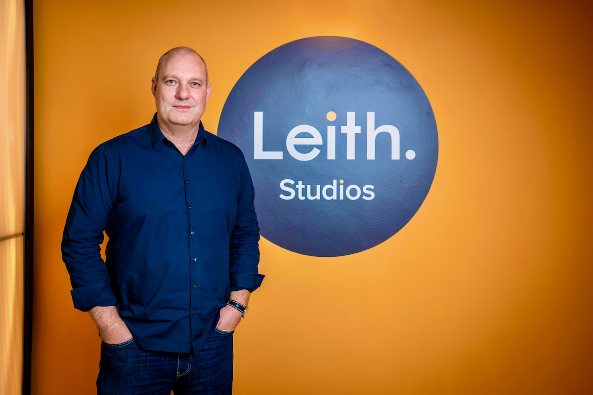Neil Williams, Head of Production, standing beside Leith Studios logo